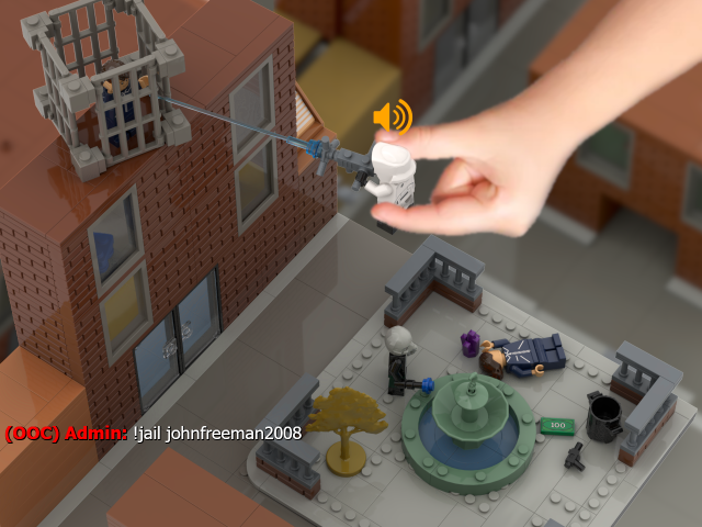 A LEGO diorama of the rp_downtown spawn area. A LEGO minifigure of the Half-Life 2 Citizen model lies on the ground, next to a purple crystal. Nearby, a pistol and money have also fallen to the ground. A minifigure of the Half-Life 2 Metro-Police model looks over the scene, holding a stunstick. Above, a child's hand reaches down, holding a minifigure of the Half-Life 2 Combine Elite model over the diorama. The minifigure is holding a Garry's Mod Physgun, pointed at a nearby rooftop, where another Citizen minifigure stands inside a cage. A voice chat icon floats above the Combine Elite minifigure's head, and text in the corner reads "(OOC) Admin: !jail johnfreeman2008".